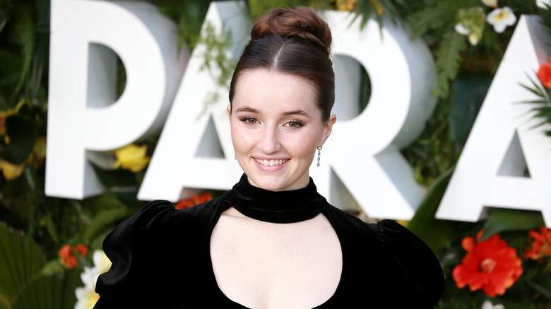 Kaitlyn Dever posing on the red carpet at premiere of Ticket to Paradise