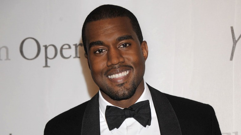 Kanye West smiling in a tuxedo