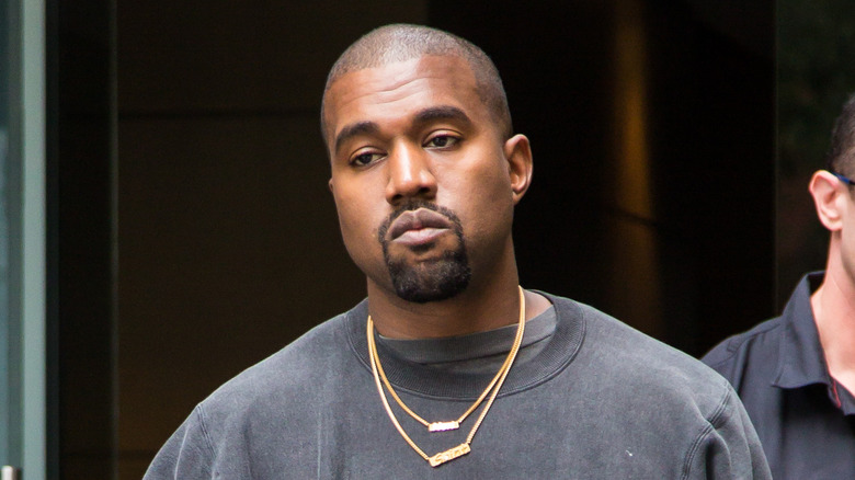 Kanye West wearing gold necklaces
