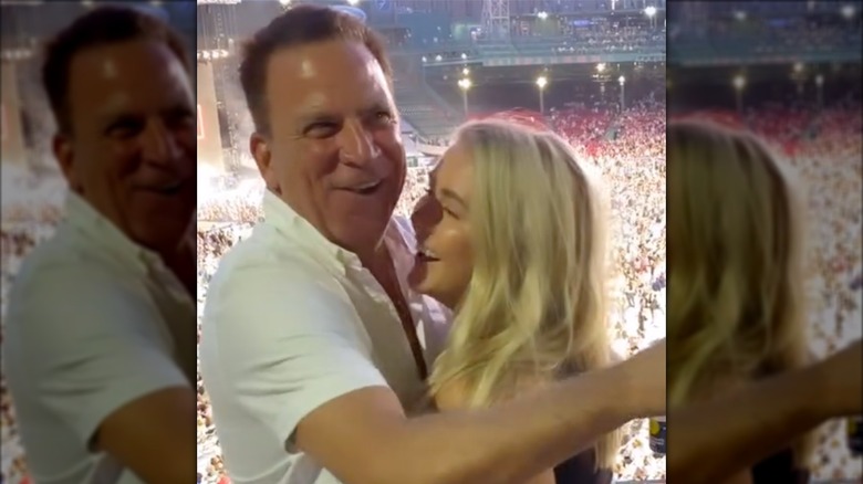 Karoline Leavitt and Nicholas Riccio embracing and smiling at a concert