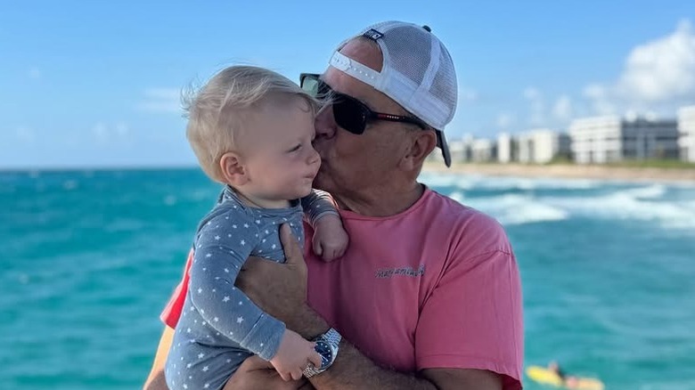 Nicholas Riccio holding his son in Palm Beach