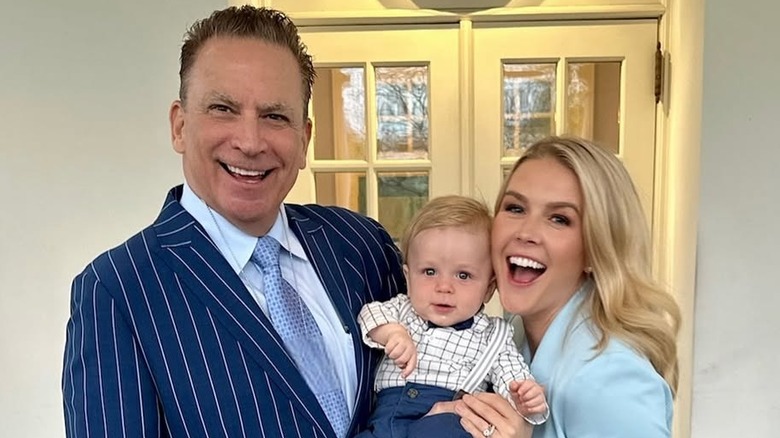 Nicholas Riccio and Karoline Leavitt posing with their son outside White House