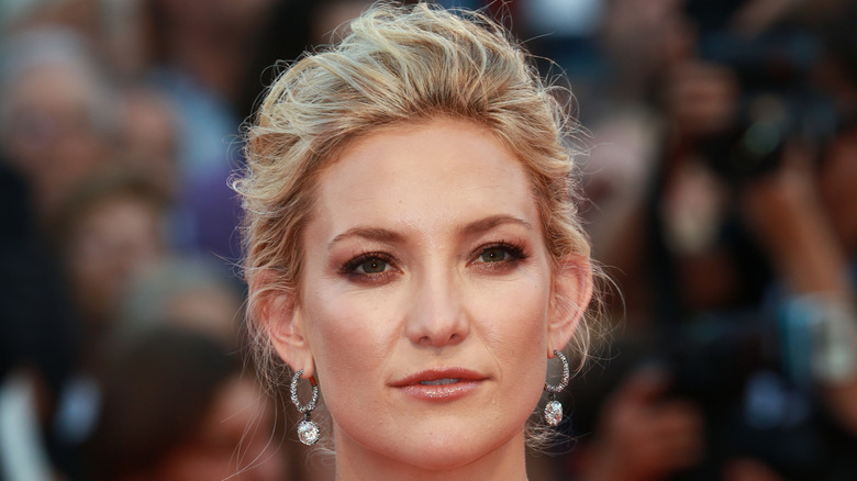 Kate Hudson looks on