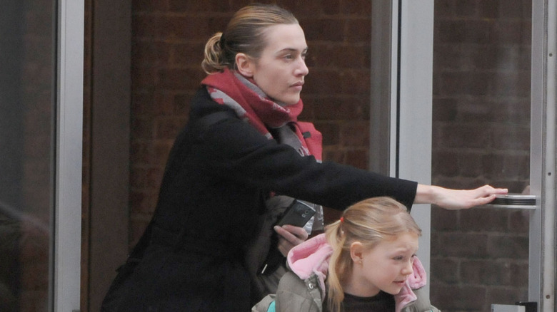 Kate Winslet holding the door for her daughter Mia