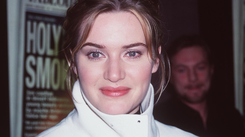 Kate Winslet in a white jacket, posing
