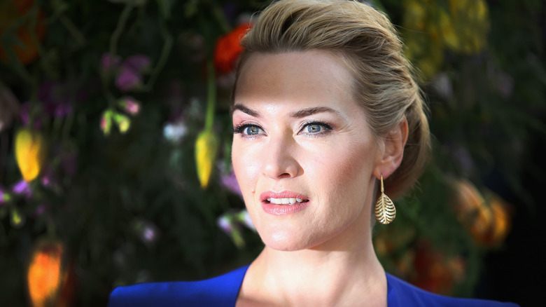 Kate Winslet in front of flowers