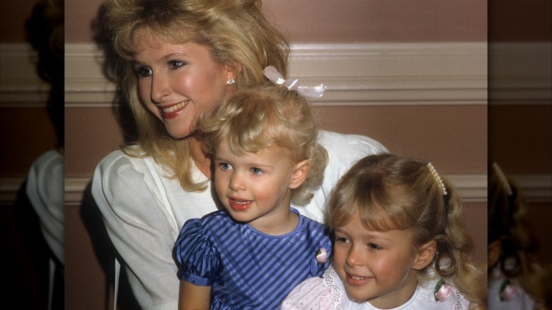 Kathy, Paris and Nicky Hilton at an event, smiling