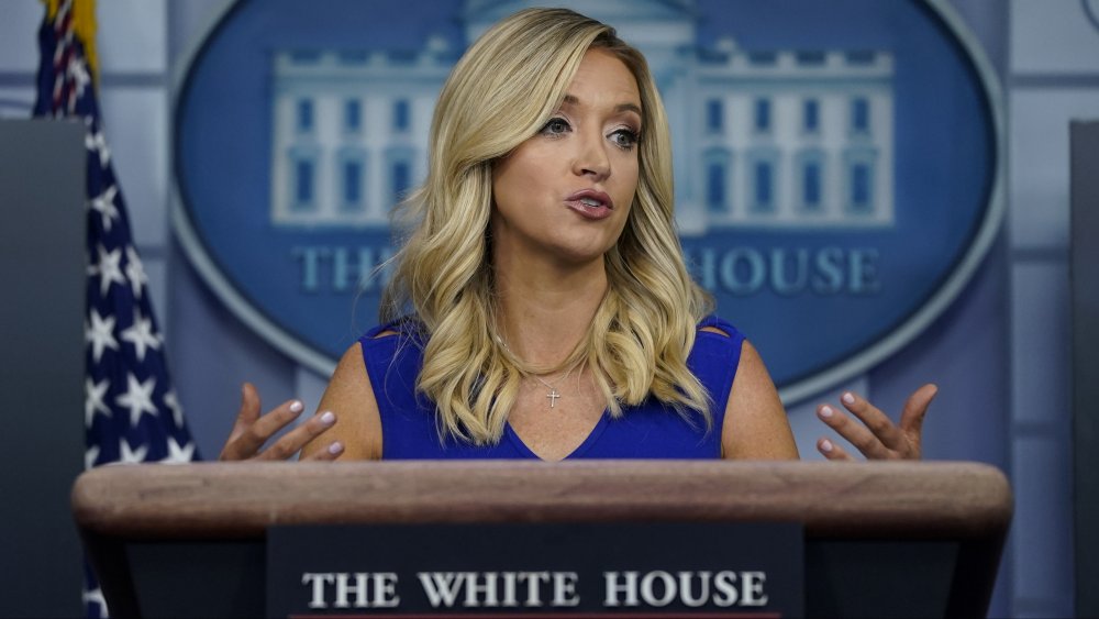 Kayleigh McEnany in a blue dress, speaking during a White House press briefing