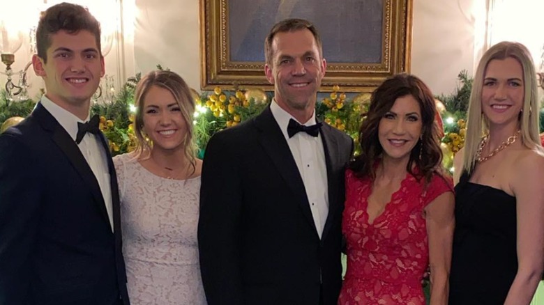 Kristi Noem and her husband posing for a photo with their adult children