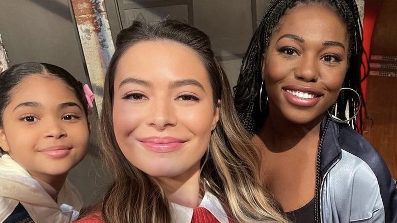 Miranda Cosgrove, taking a selfie with Laci Mosley, smiling