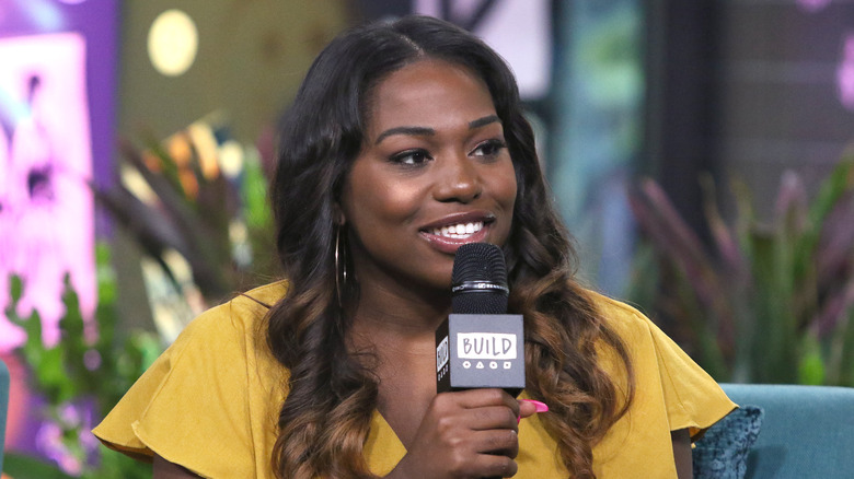 Laci Mosley, smiling, speaking into a microphone 