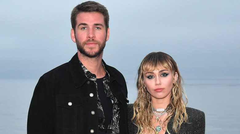 Liam Hemsworth and Miley Cyrus outdoors