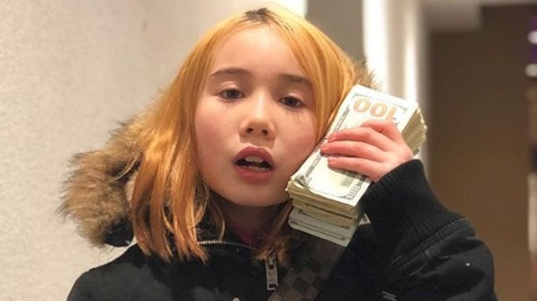 Lil Tay holding money