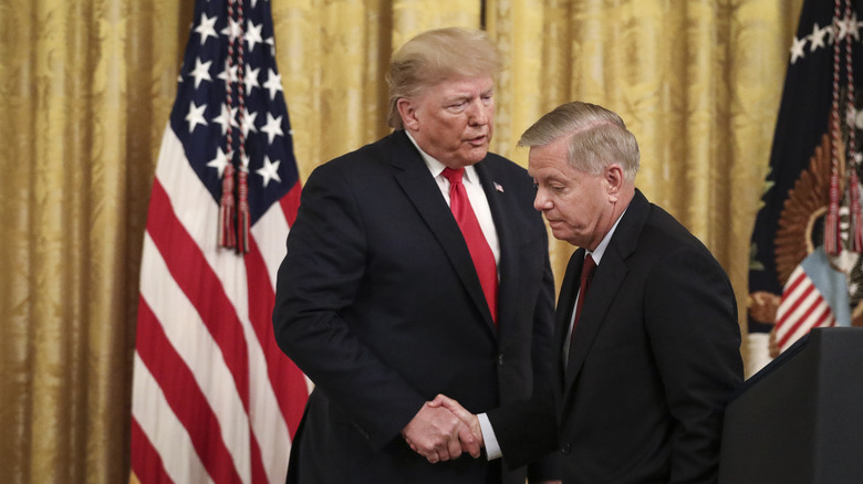 Lindsey Graham shaking hands with Donald Trump