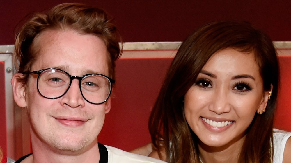 Macaulay Culkin and Brenda Song, posing together and smiling