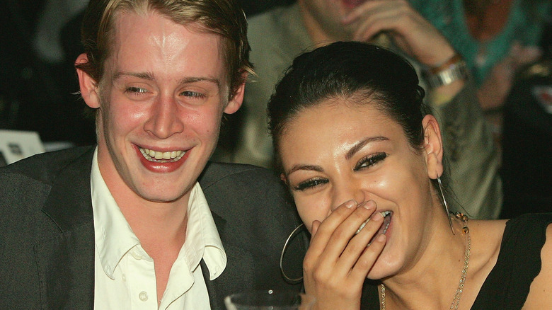 Macaulay Culkin and Mila Kunis laughing 