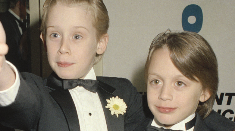 Macaulay Culkin posing with his little brother 
