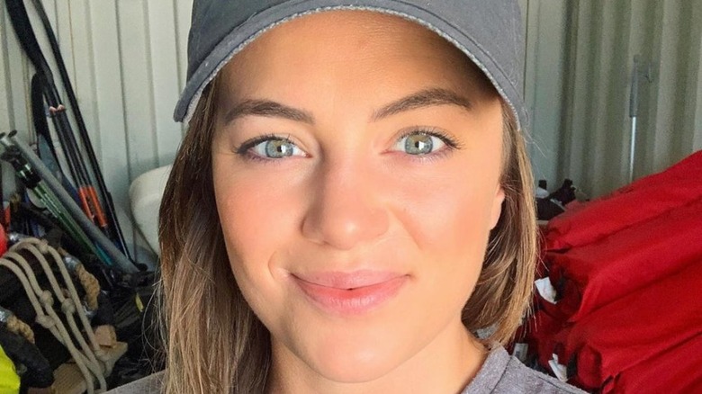 Malia White wearing a hat