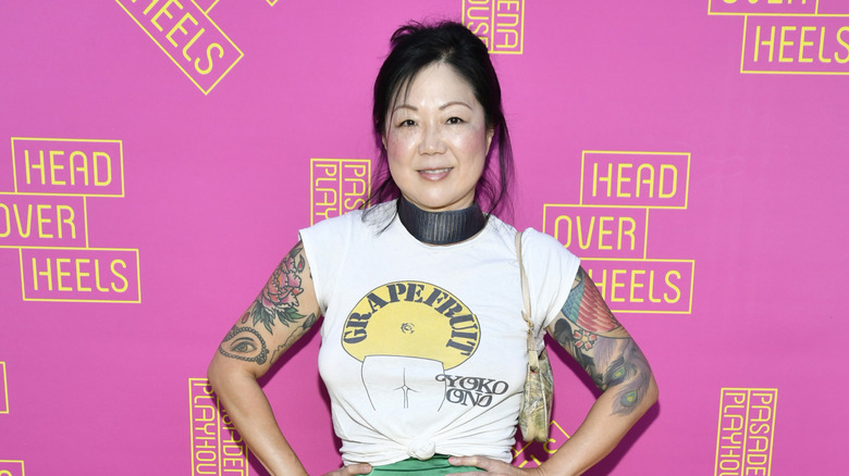 Margaret Cho smiling in front of pink background
