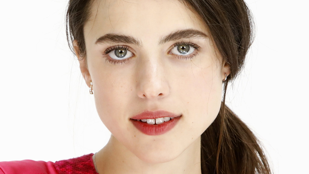 Margaret Qualley smiling in a portrait 