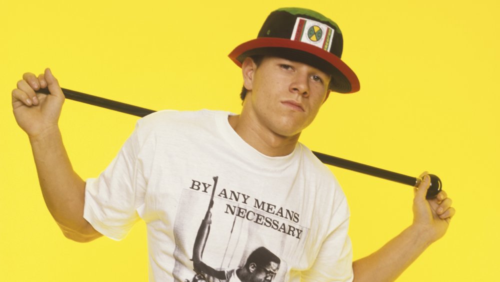 Mark Wahlberg in the '90s, in front of a yellow wall