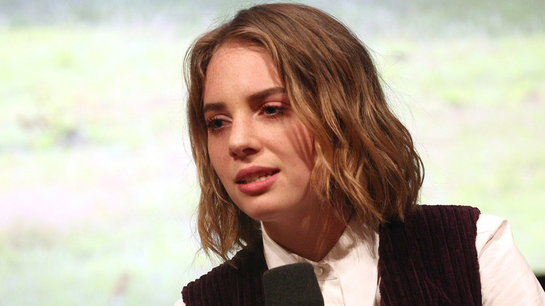 Maya Hawke holding a microphone
