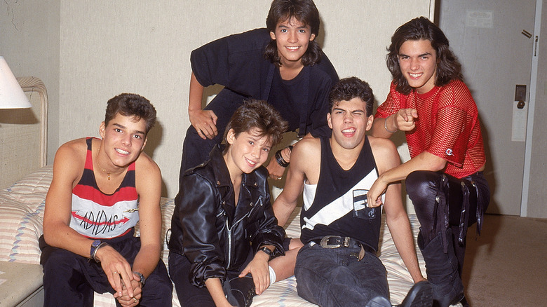 Young Menudo members posing together