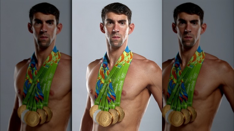 Michael Phelps posing with medals