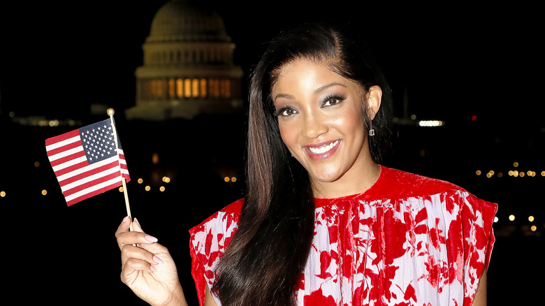 Mickey Guyton holding an American flag