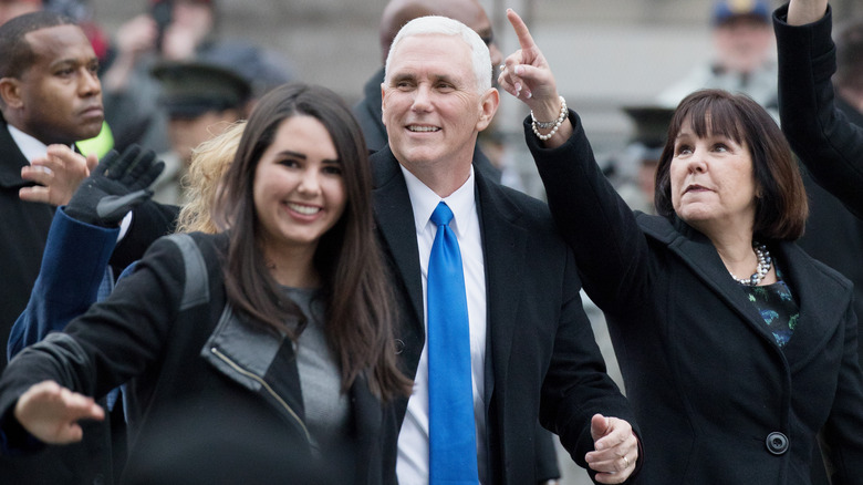 Audrey Pence walking with parents Mike and Karen Pence