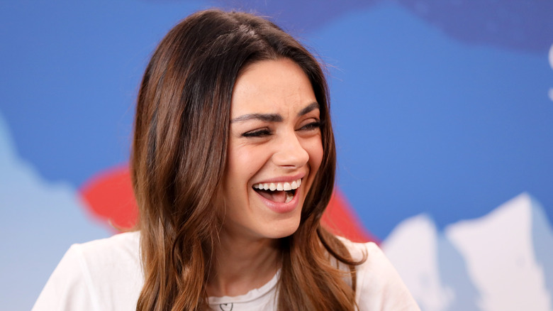 Mila Kunis laughing