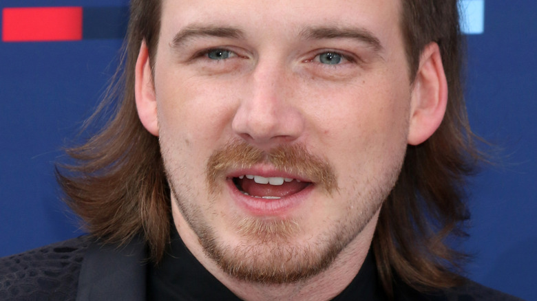 Morgan Wallen wearing a black suit