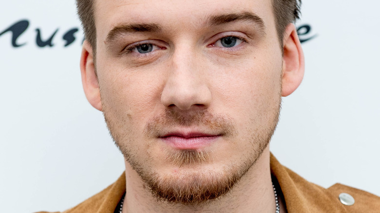 Morgan Wallen wearing a brown jacket