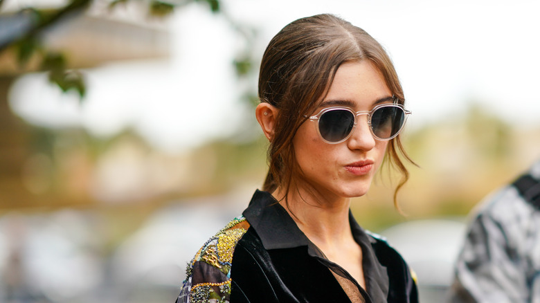 Natalia Dyer wearing sunglasses