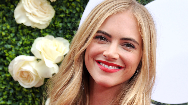 Emily Wickersham smiling with flowers