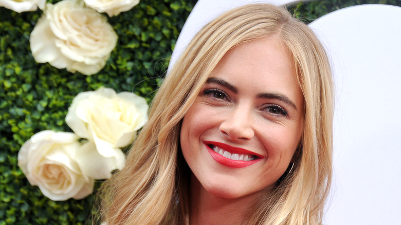 Emily Wickersham smiling with flowers