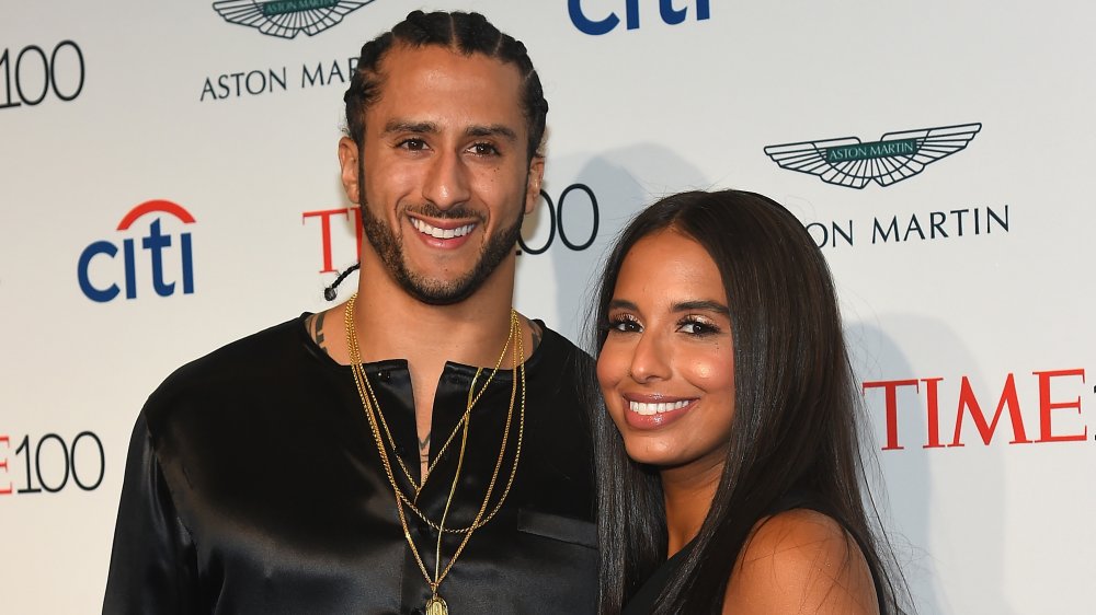 Colin Kaepernick and Nessa Diab, both wearing black and smiling at a Time 100 event