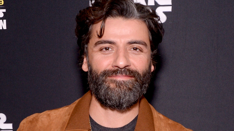 Oscar Isaac in a brown jacket