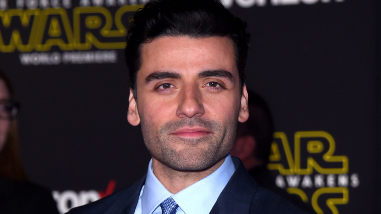 Oscar Isaac wearing a blue tie