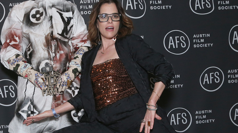 Parker Posey posing in sequin top