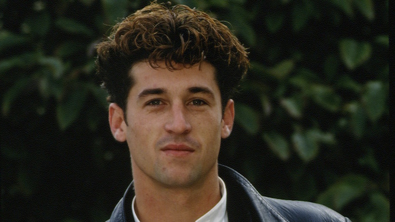 Patrick Dempsey posing in front of bushes