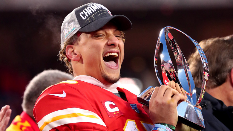 Patrick Mahomes celebrating with trophy