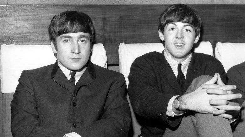 Paul McCartney and John Lennon, both seated