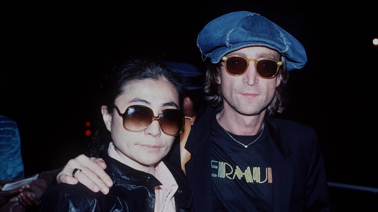 John Lennon and Yoko Ono, arm in arm