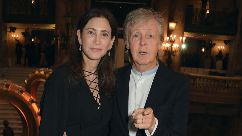 Paul McCartney and Nancy Shevell, both smiling at cameras