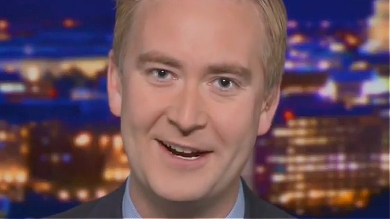 Peter Doocy smiling while reporting on air