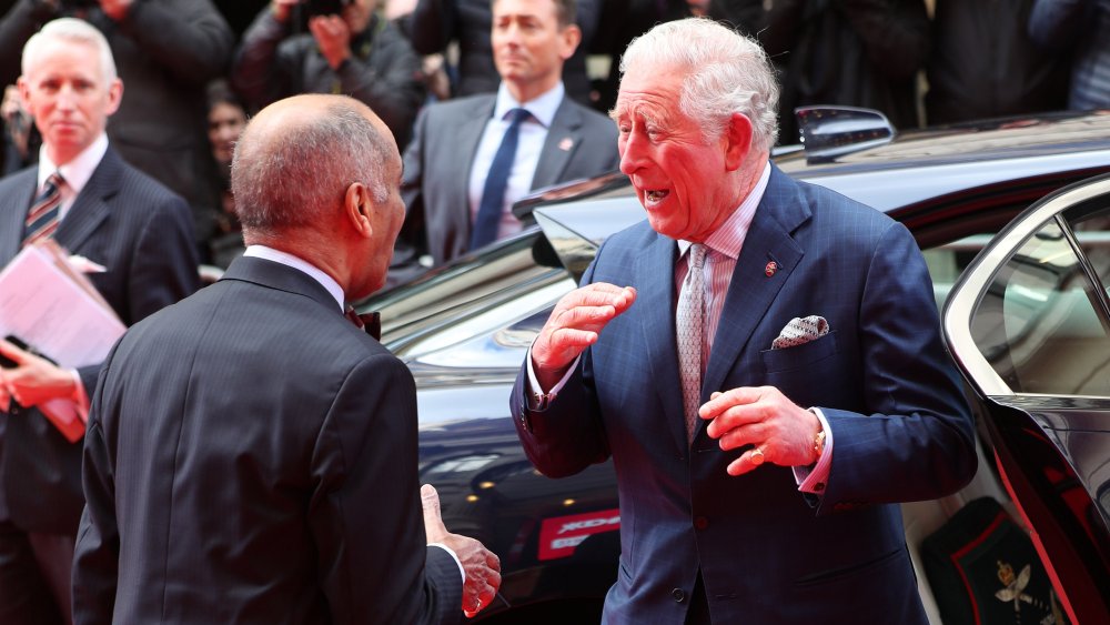 ﻿Sir Kenneth Olisa and Prince Charles almost shaking hands