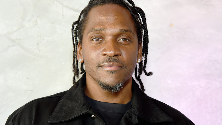 Pusha T with some gray in his beard, smiling