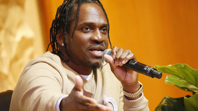 Pusha T talking into a microphone
