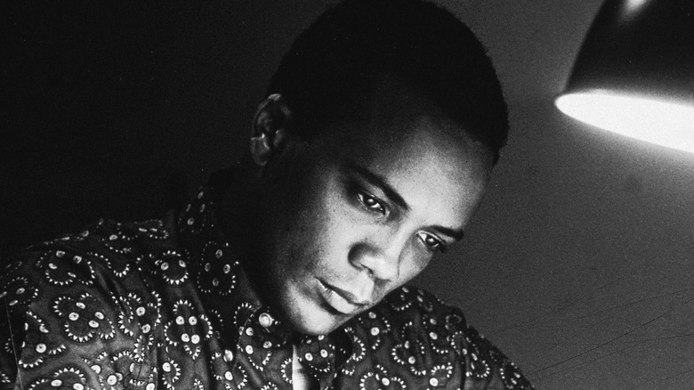 Quincy Jones writing by lamplight